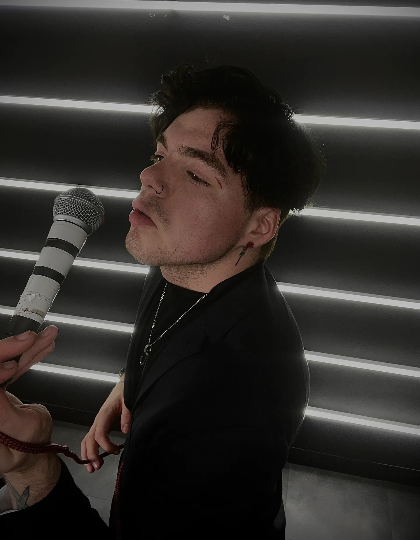 James Laurent with a microphone in front of an LED wall