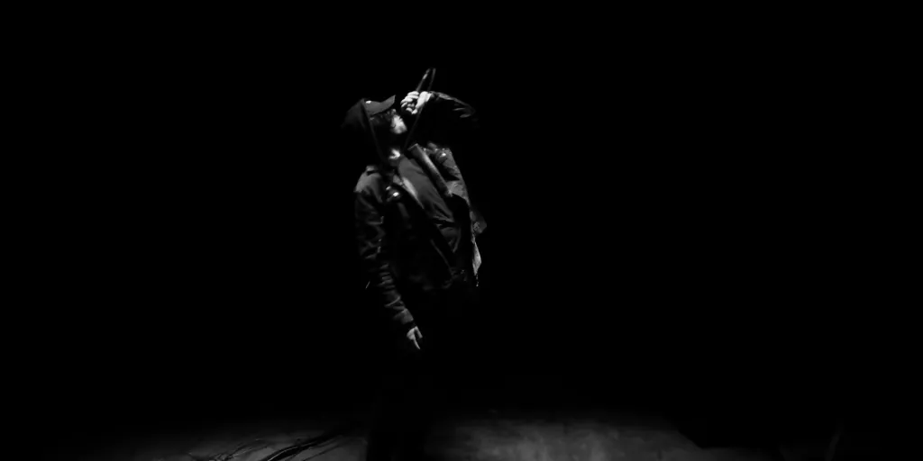 James Laurent onstage under a hard light